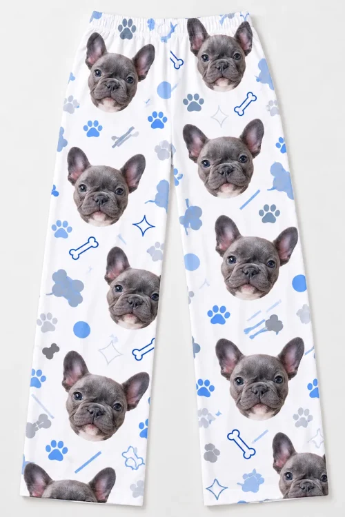 Women's pet face pajama pants laid flat: French bulldog faces, bones and paw prints