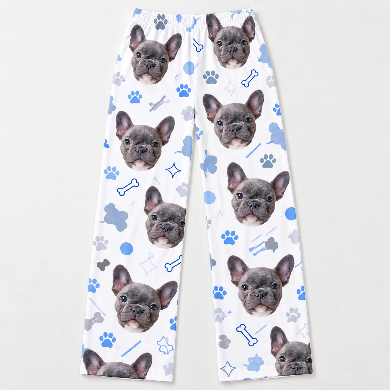 Custom Pet Face Pajama Pants — flat lay womens | GenzOutfit Women's pet face pajama pants laid flat: French bulldog faces, bones and paw prints