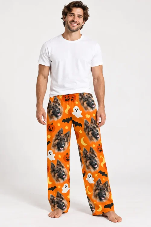 Man in pet face pajama pants: German shepherd faces on orange with Halloween bats and ghosts