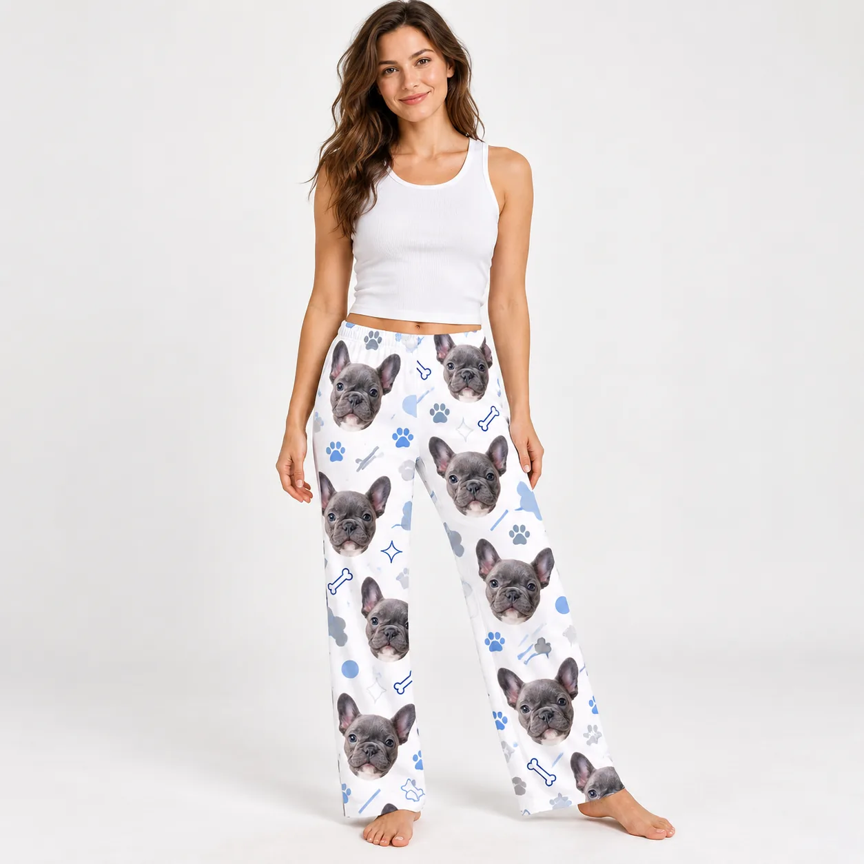 Custom Pet Face Pajama Pants — front womens | GenzOutfit Woman in a white tank top and pet face pajama pants with French bulldog faces and paws