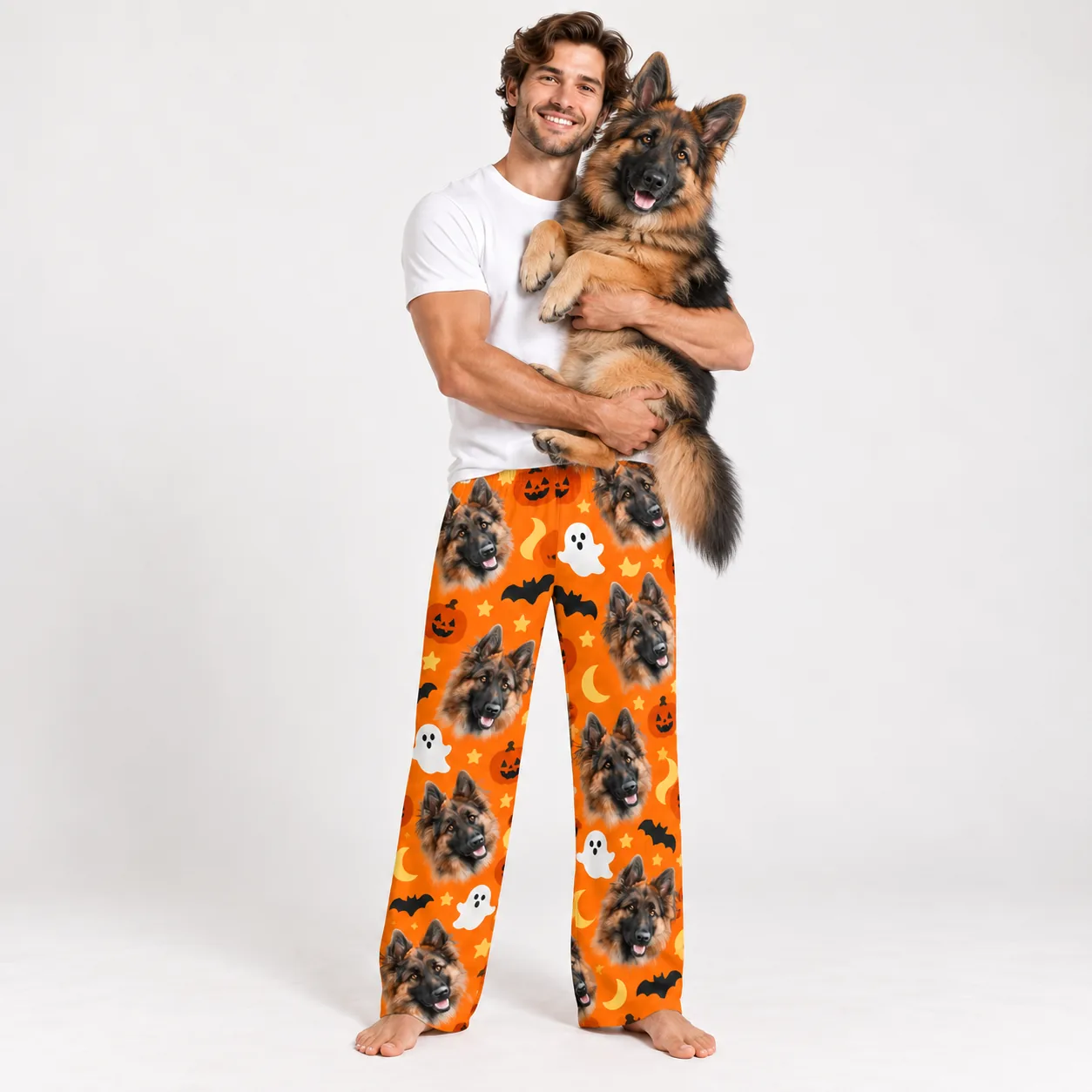 Custom Pet Face Pajama Pants — with dog holding mens | GenzOutfit Man holding his German shepherd in pet face pajama pants with a Halloween print