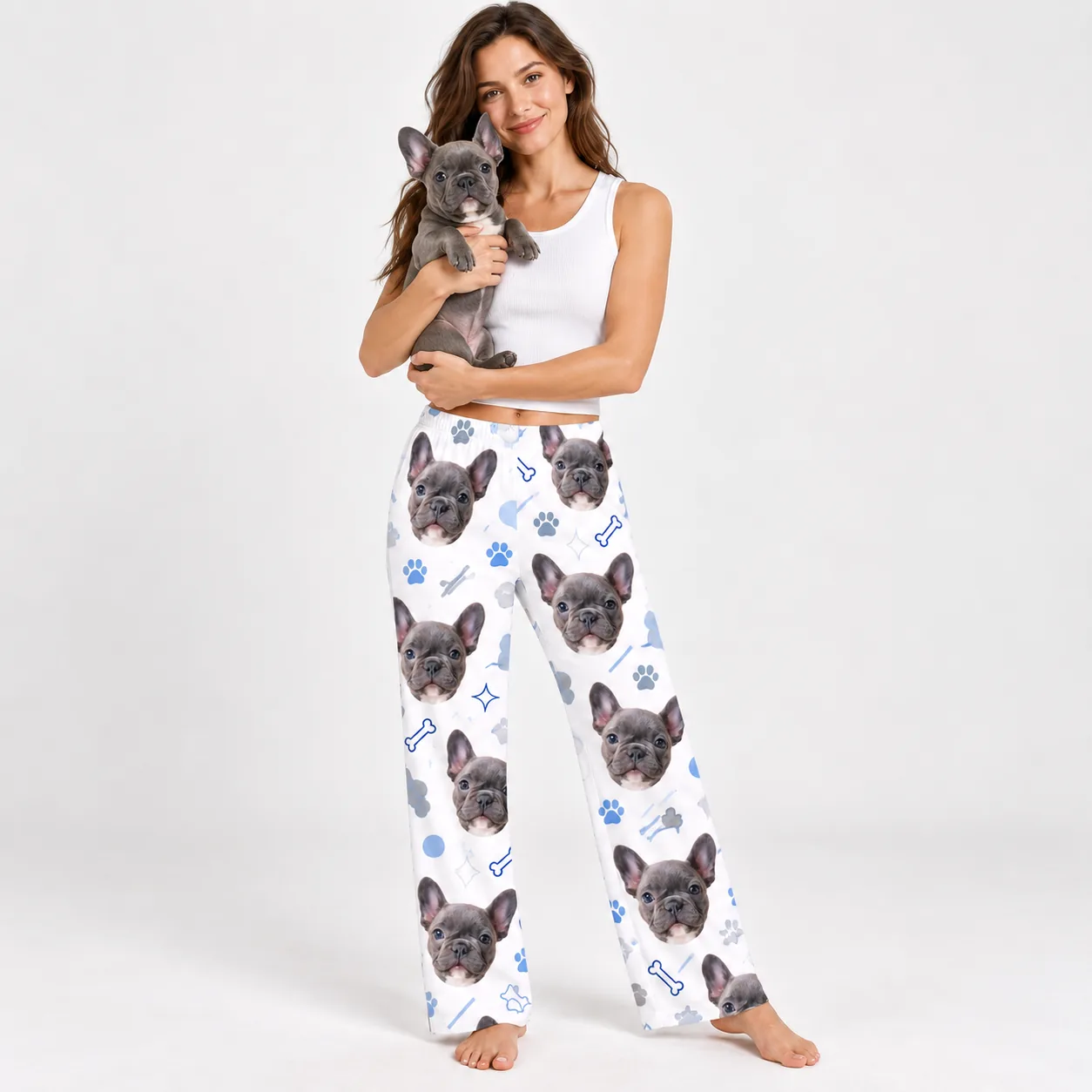 Custom Pet Face Pajama Pants — with dog holding | GenzOutfit Woman holding her French bulldog, wearing pajama pants printed with its face