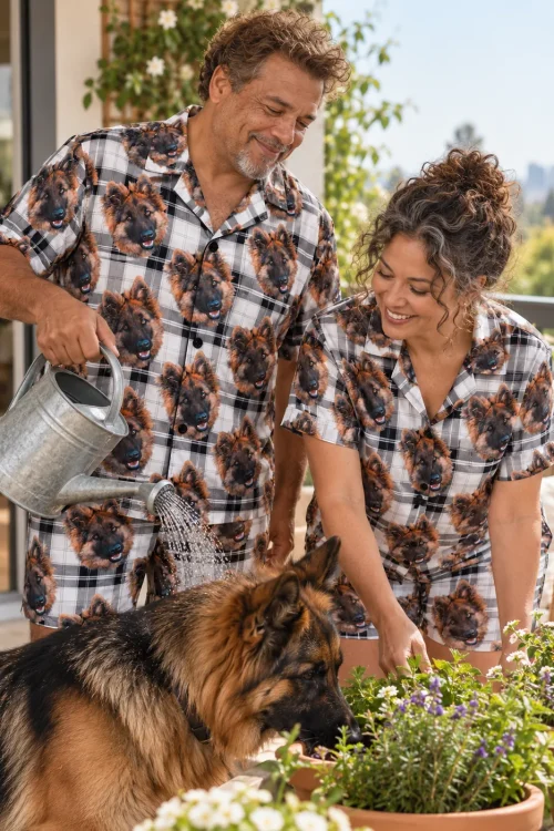 Couple watering potted flowers on a sunny terrace in white plaid German shepherd pajama sets with their German shepherd