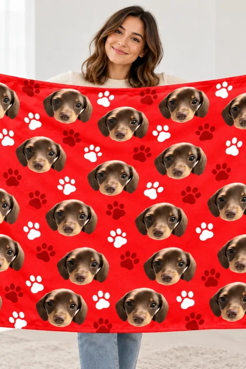 Woman holding up the pet face sherpa blanket to show its size