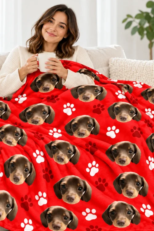 Woman with a mug relaxing on the sofa under the pet face sherpa blanket