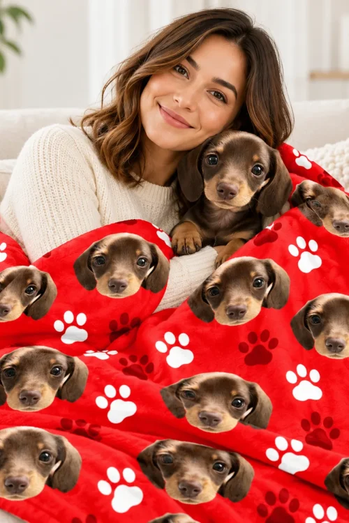 Woman cuddling her dachshund under the pet face sherpa blanket