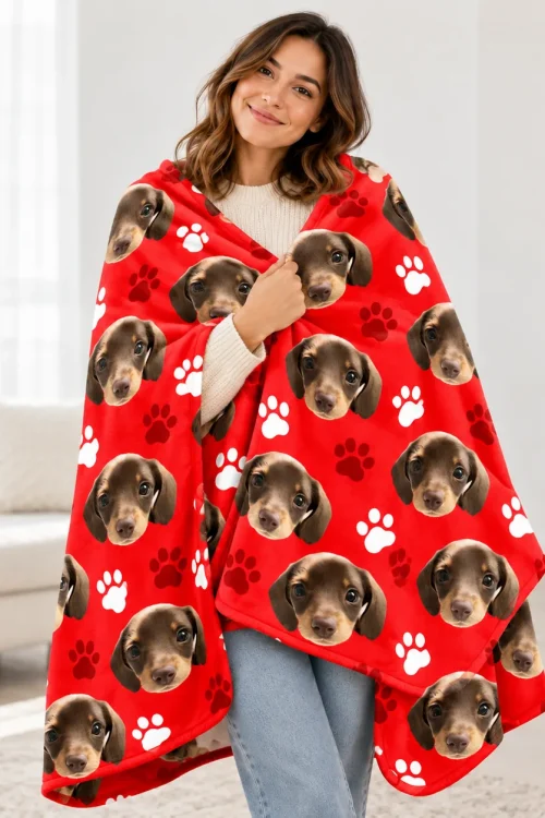 Woman wrapped in the red pet face sherpa blanket with dachshund print