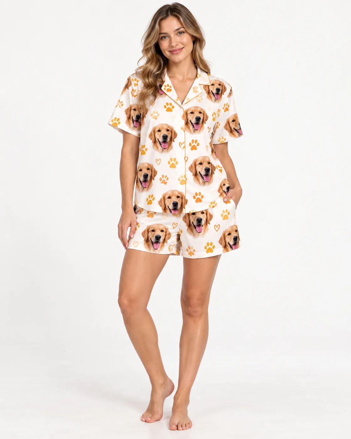 Woman in a cream short pajama set printed with a golden retriever's face, showing shirt and shorts length