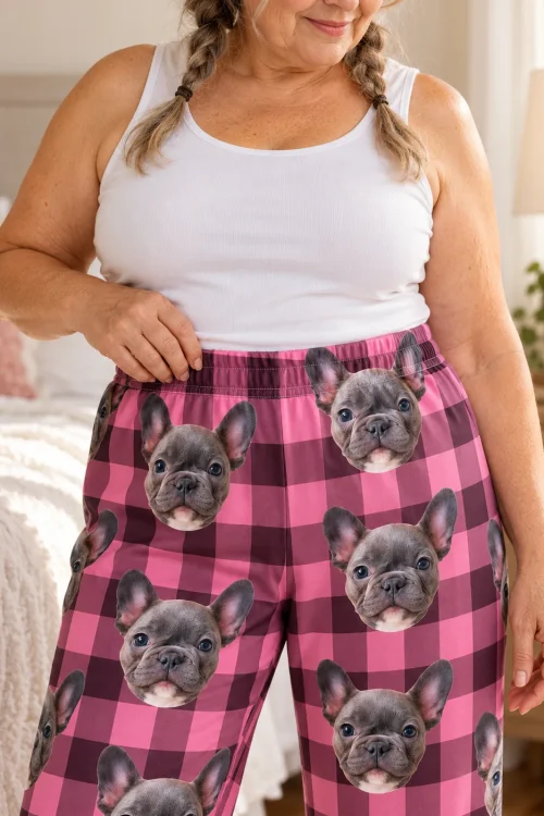 Close view of pink plaid pajama pants with French bulldog faces and an elastic waistband