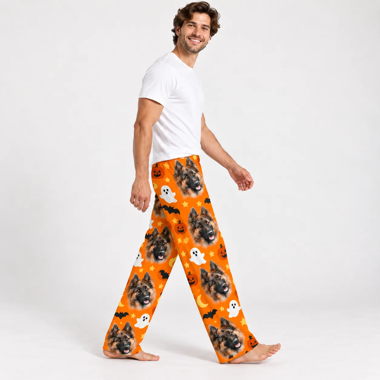 Side view of a man walking in long orange Halloween pajamas with a dog face print