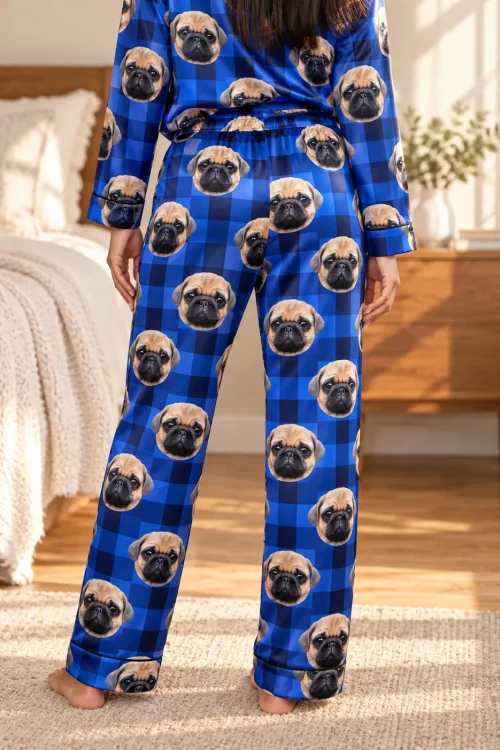 Back view of blue plaid pajamas with pug faces and an elastic waistband in a sunny bedroom