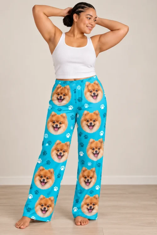 Woman with braids and hands behind her head, barefoot in teal paws pomeranian pajama pants on a wood floor