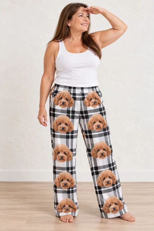 Smiling woman shading her eyes, standing barefoot in white plaid poodle pajamas for women