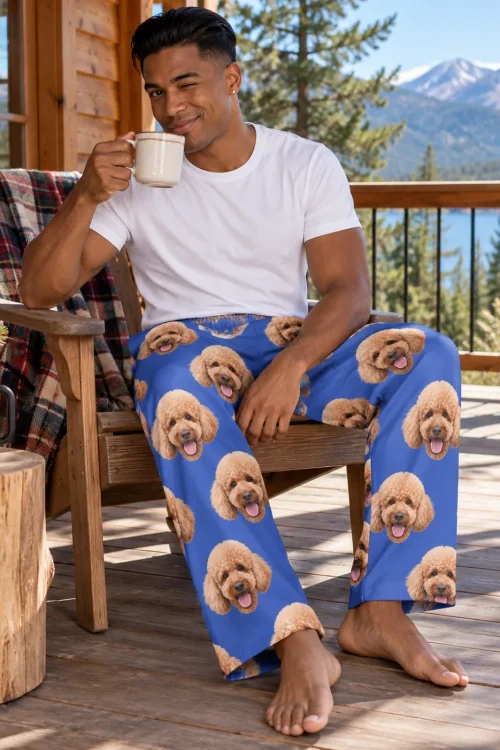 Man winking with a mug on a mountain cabin deck in royal blue poodle PJs