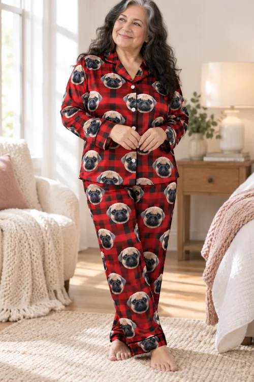 Woman standing in a bright bedroom in a red plaid pajama set with pug faces