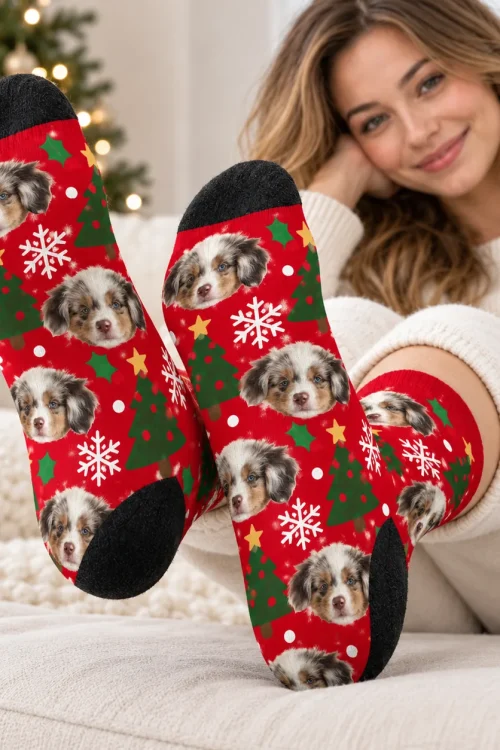 Feet up on a sofa in dog face socks, soles and black heels toward the camera