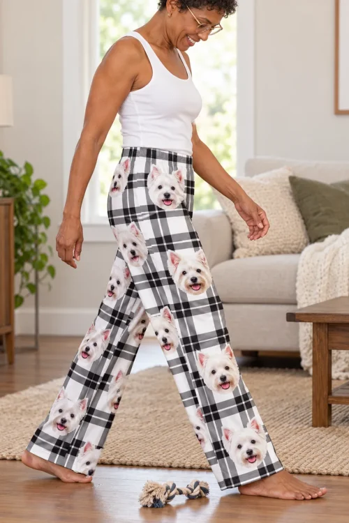 Woman in plaid Westie pajamas walking across a living room rug toward a rope toy