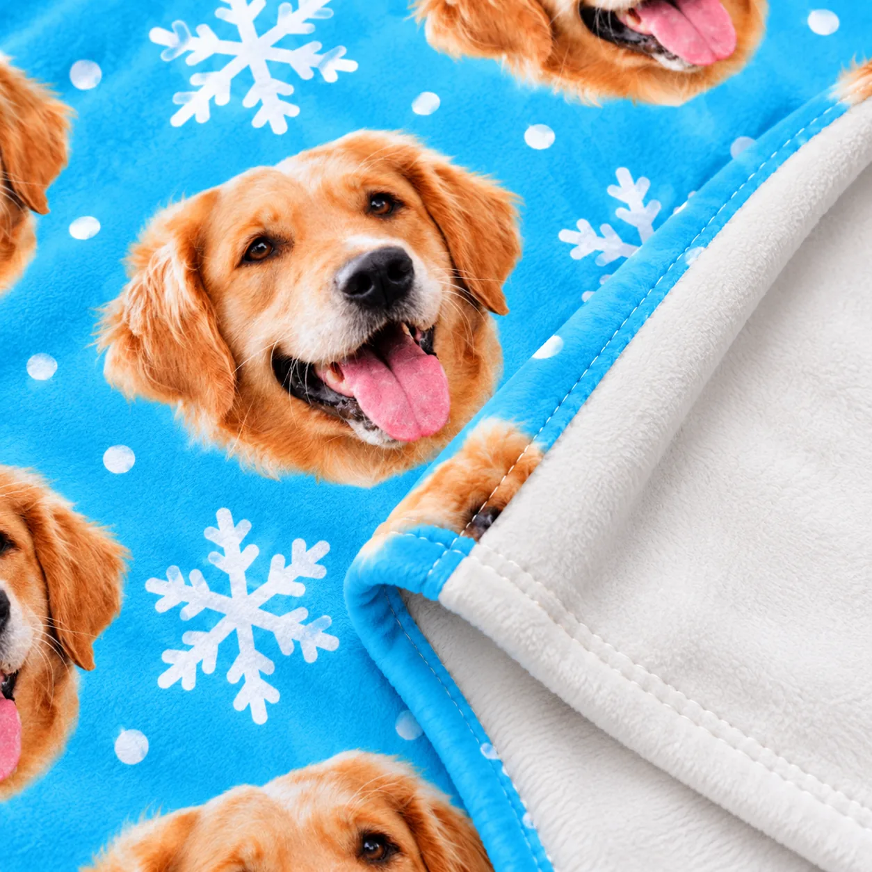 Close-up of a blue fleece blanket with a golden retriever face print and white back
