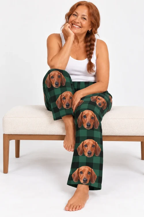 Red-haired woman with a long braid on a cream bench, wearing green plaid dachshund pajamas for women