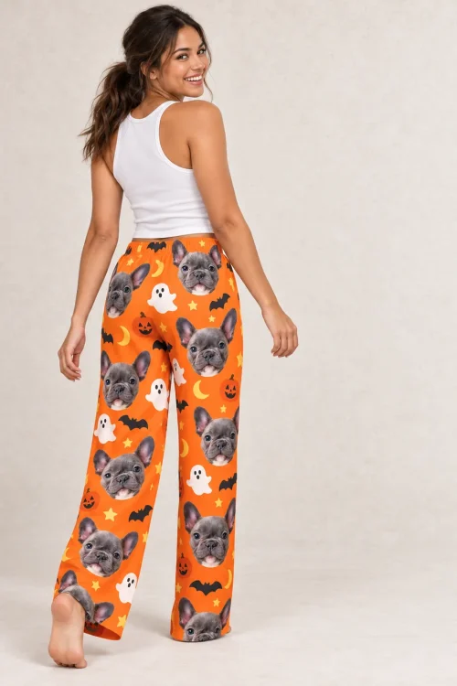 Woman looking back over her shoulder in orange Halloween pajama pants with French bulldog faces