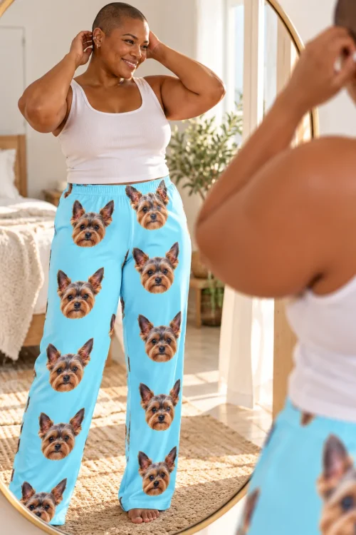 Woman checking her light blue Yorkie pajama pants in a round bedroom mirror, Yorkie faces down both legs